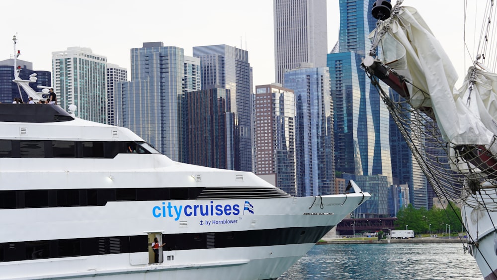 a large white boat in front of a city