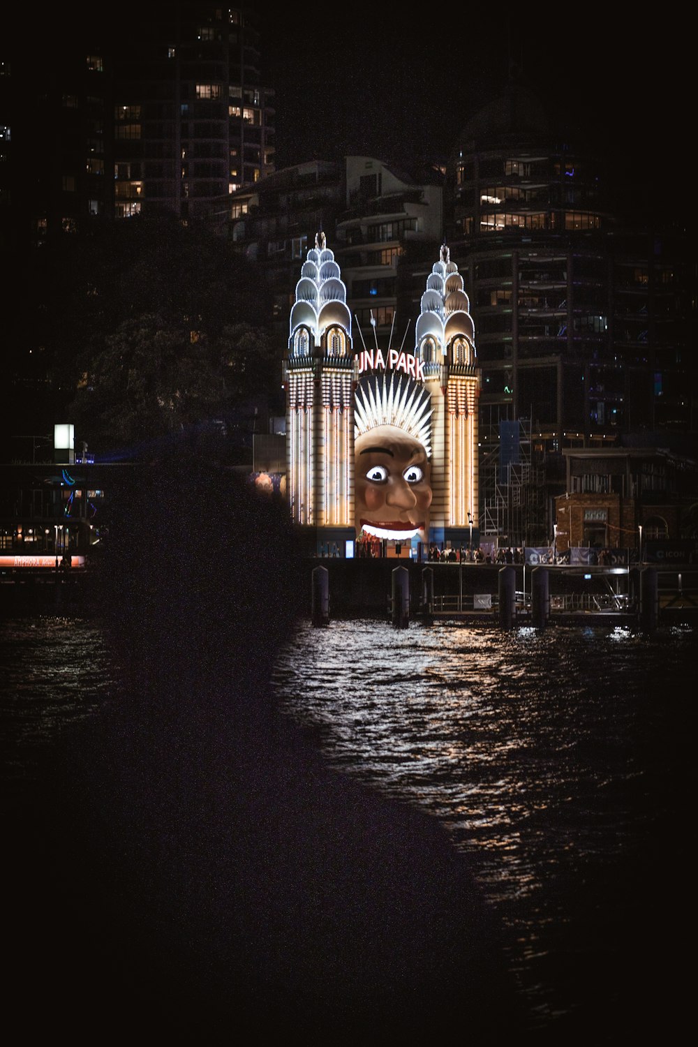 a lighted building by water