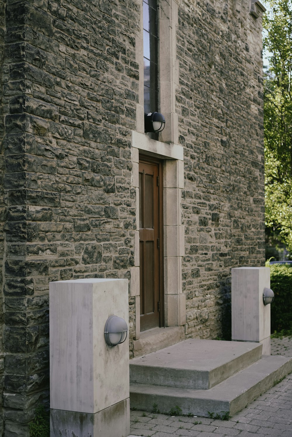 a stone building with a door and a stone pillar