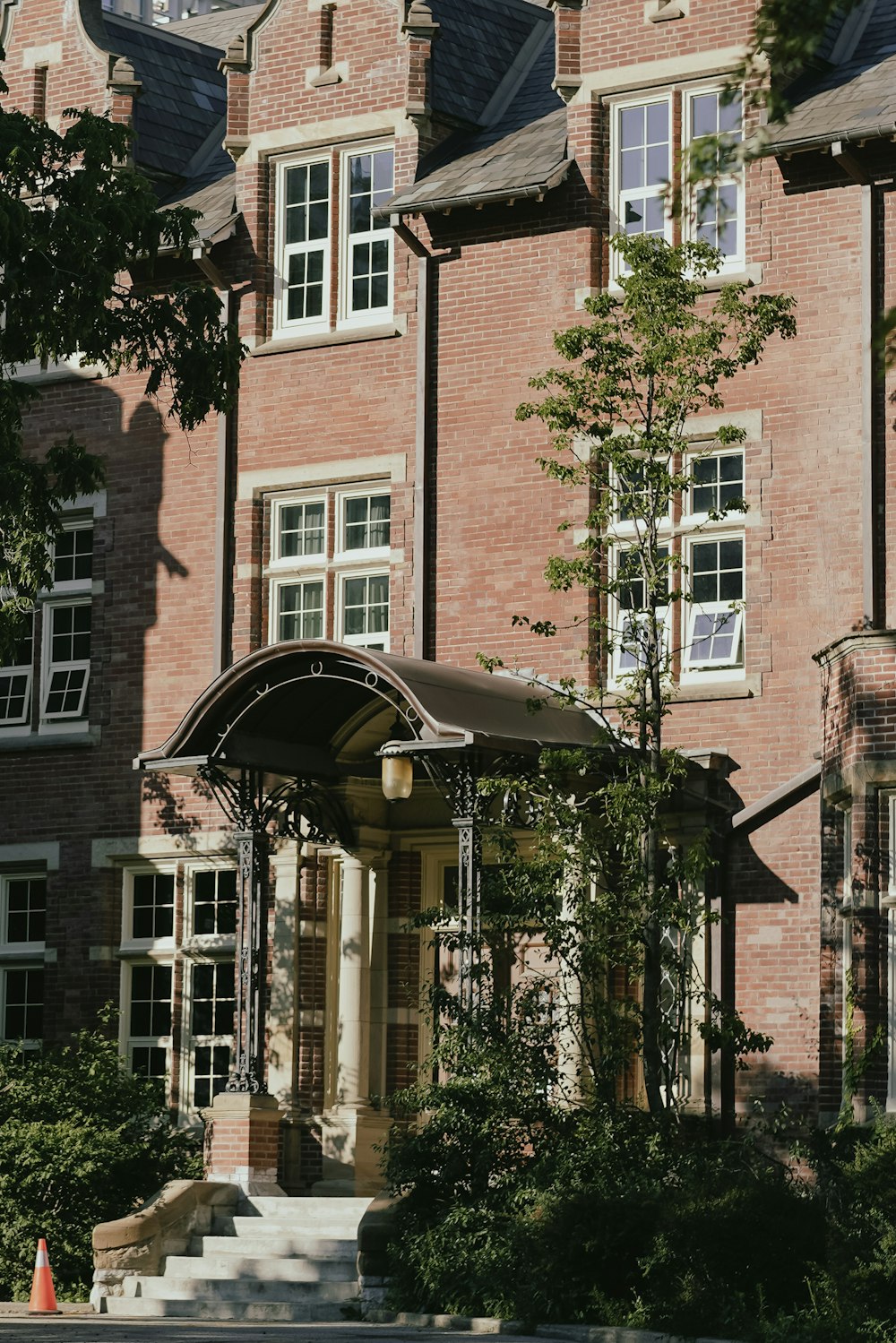 a brick building with trees in front of it