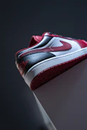 Close-up of a red and black sneaker with urban style details.