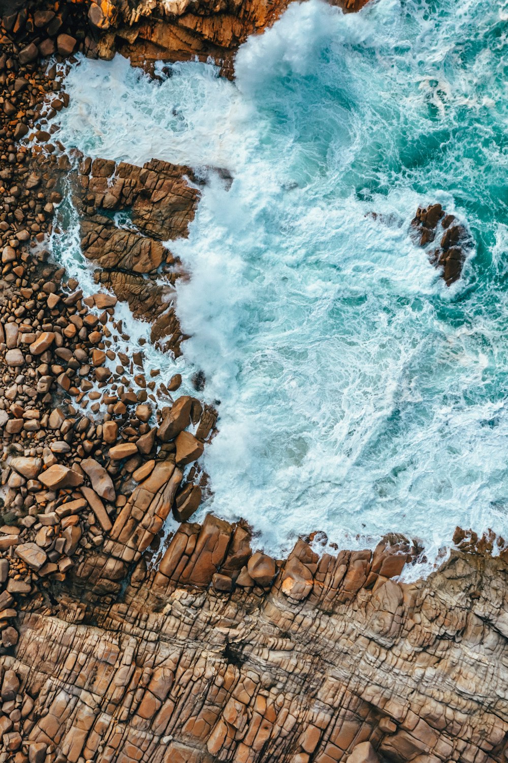 a rocky cliff with a waterfall