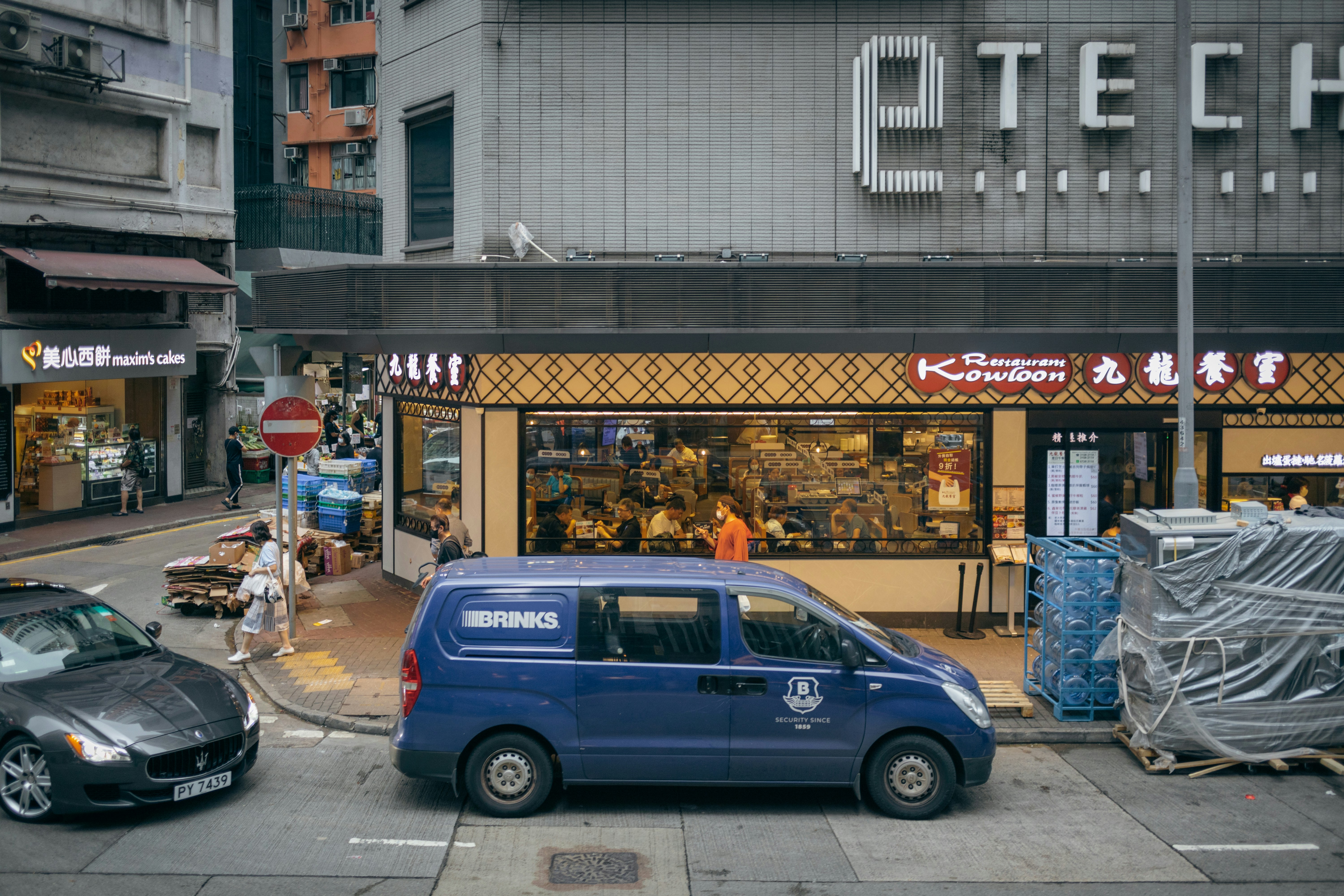 a blue car parked in front of a store