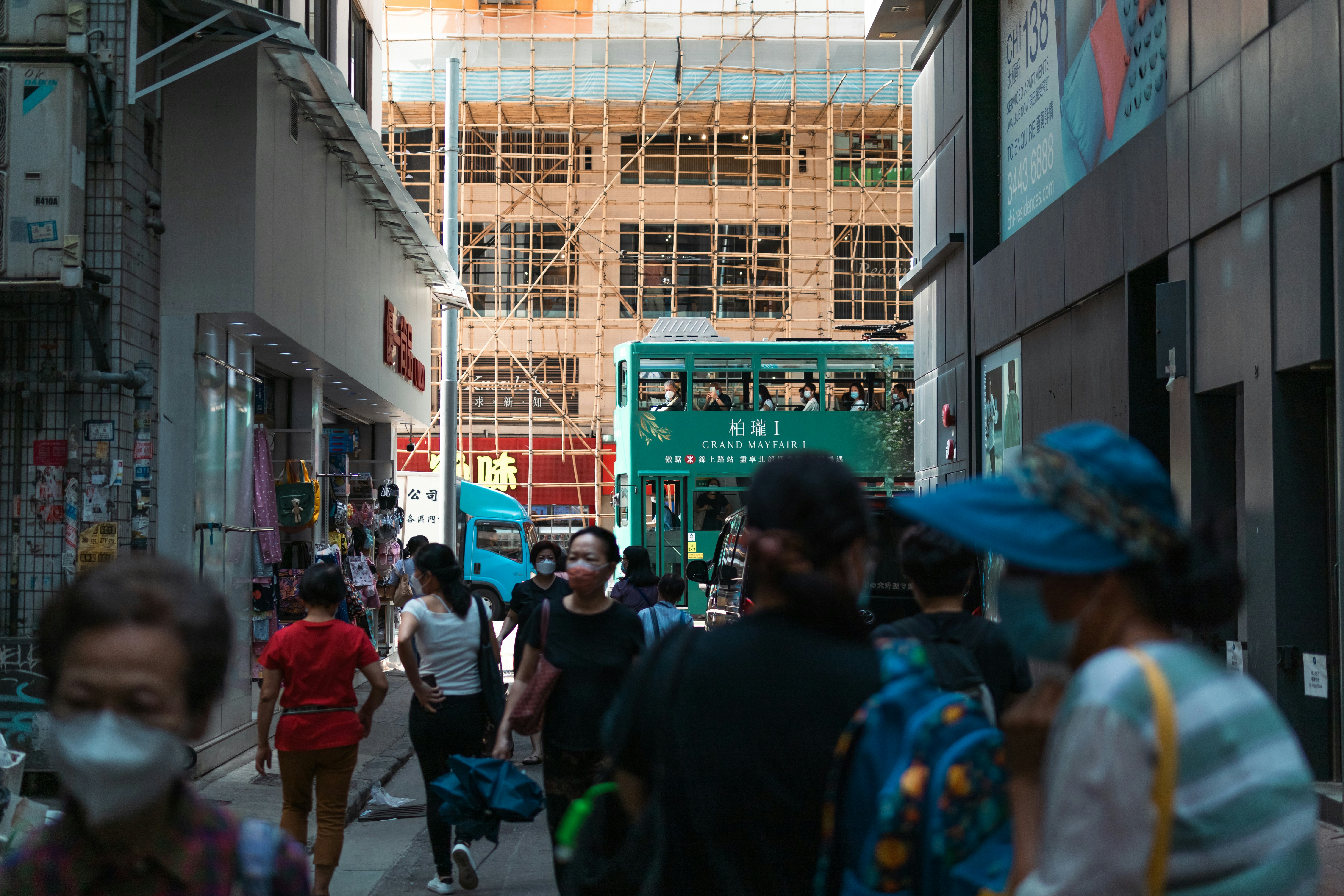 a group of people walking down a busy street