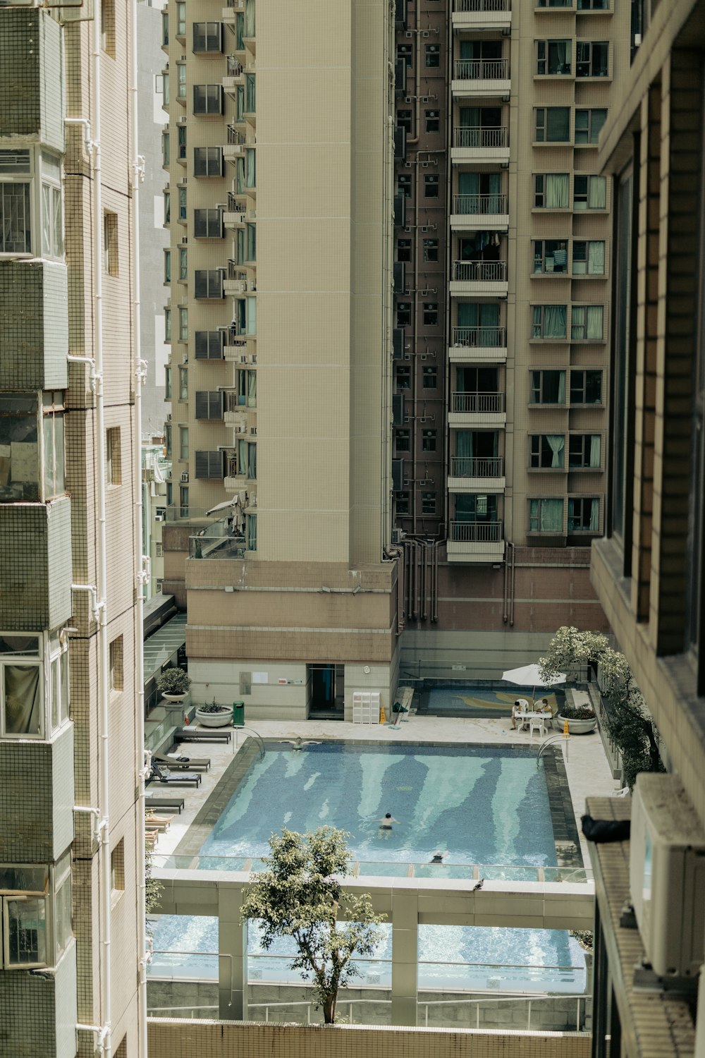 a pool in a courtyard between buildings