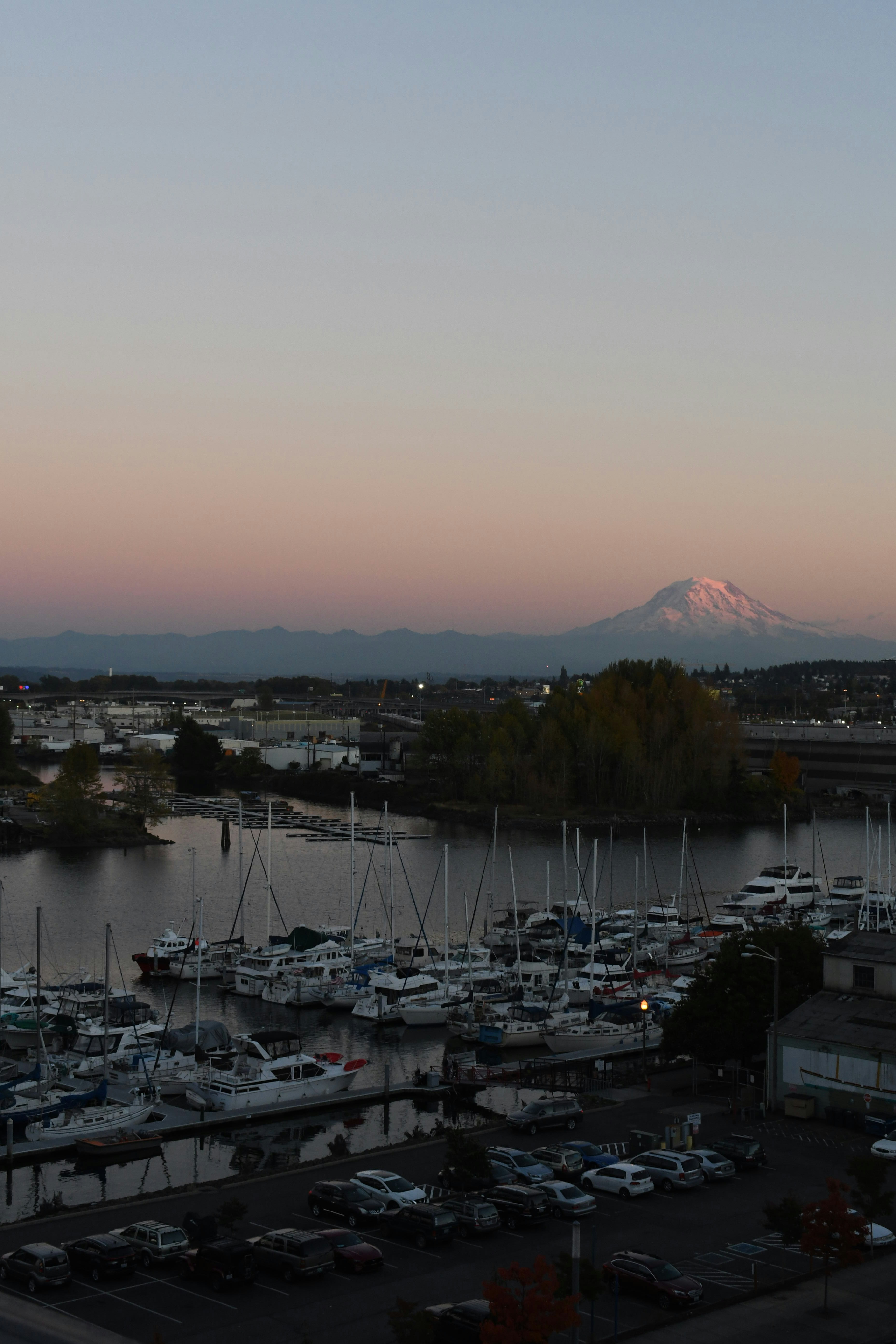 a body of water with boats and a mountain in the background