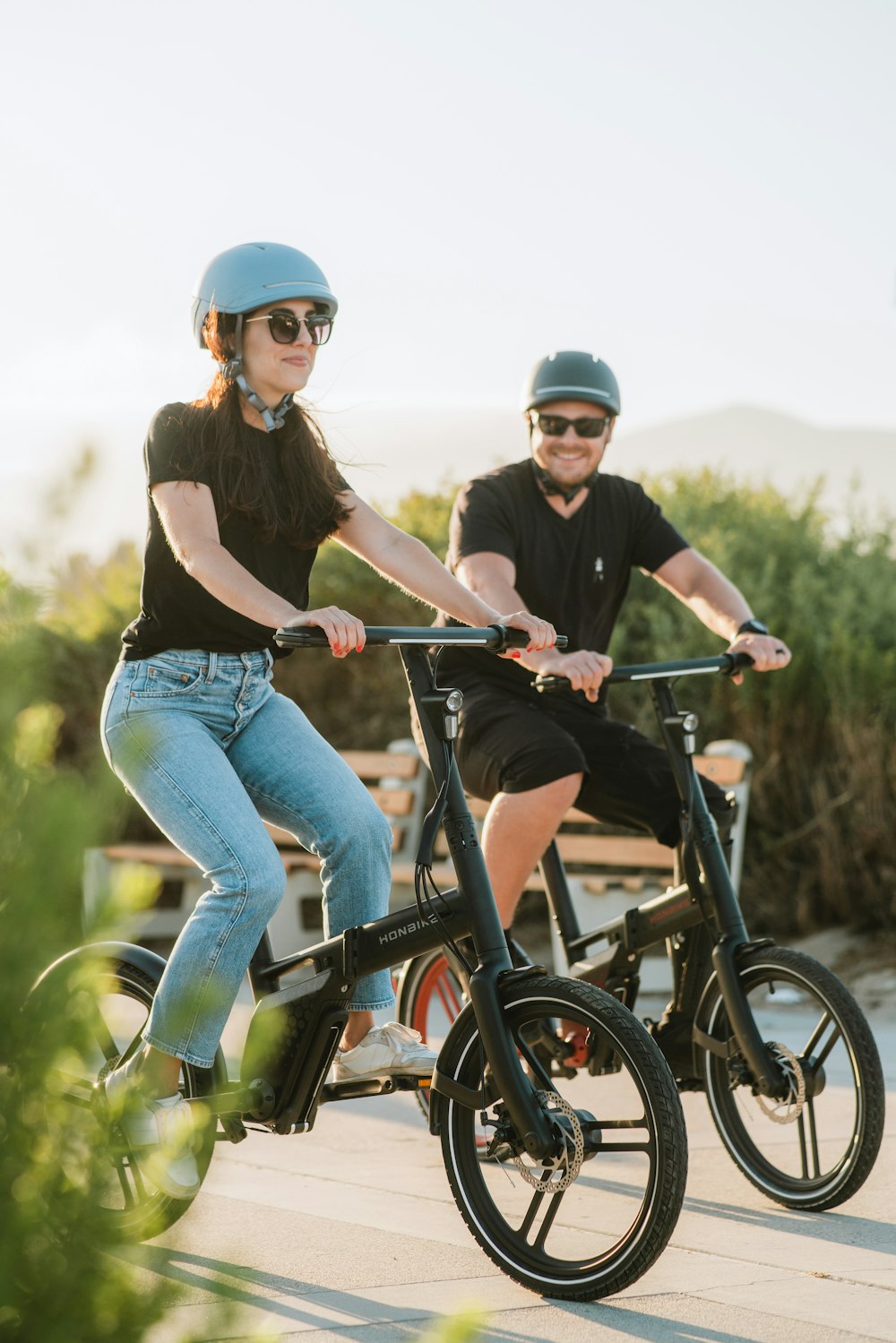 a man and a woman riding bikes