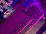 Close-up of glowing electronic circuits on a dark motherboard.