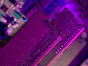 Close-up of glowing electronic circuits on a dark motherboard.
