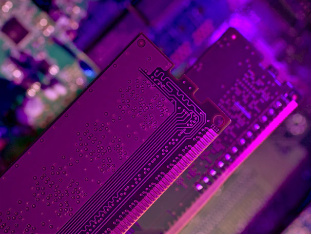Close-up of a glowing circuit board with electric purple and cyan highlights