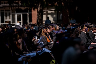 a group of people in graduation gowns and caps