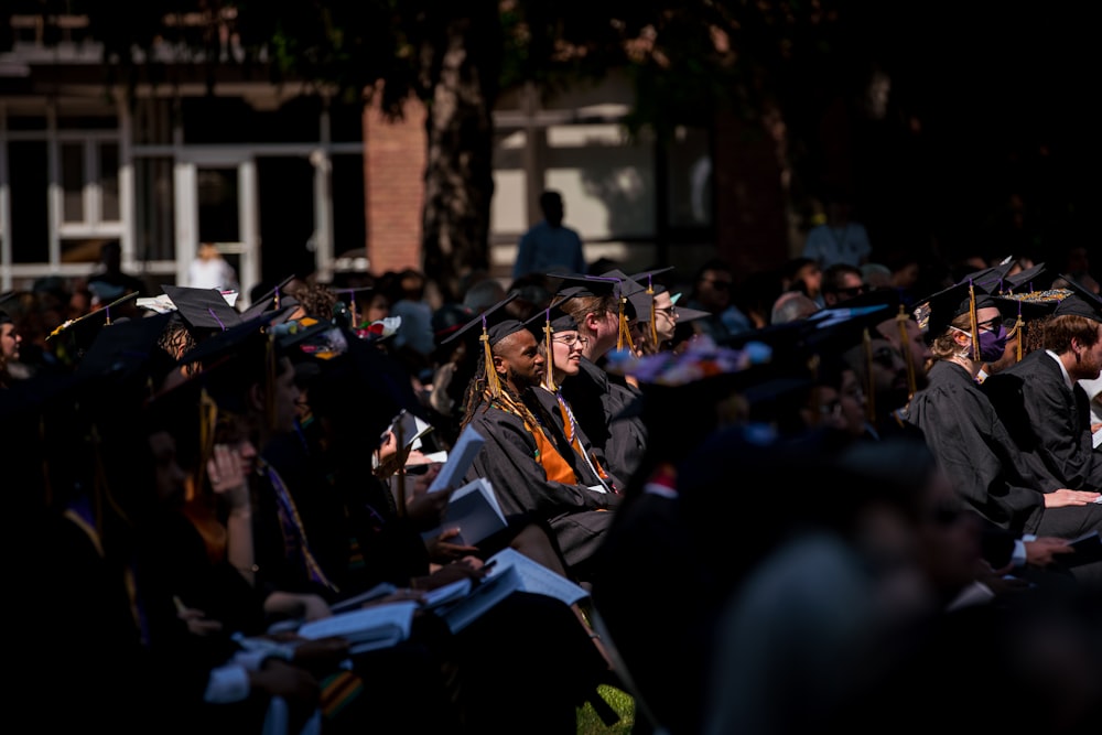 a group of people in graduation gowns and caps