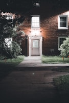 Nighttime shot of Crown House entrance illuminated by subtle outdoor lighting.