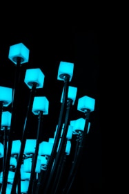 Close-up of sleek, modern LED lighting fixtures glowing with electric blue accents.