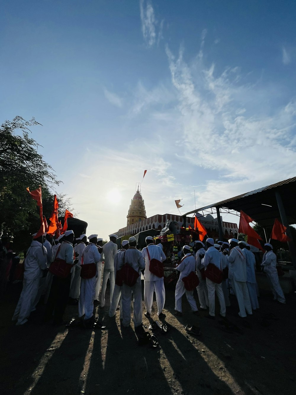 a group of people in white robes holding flags