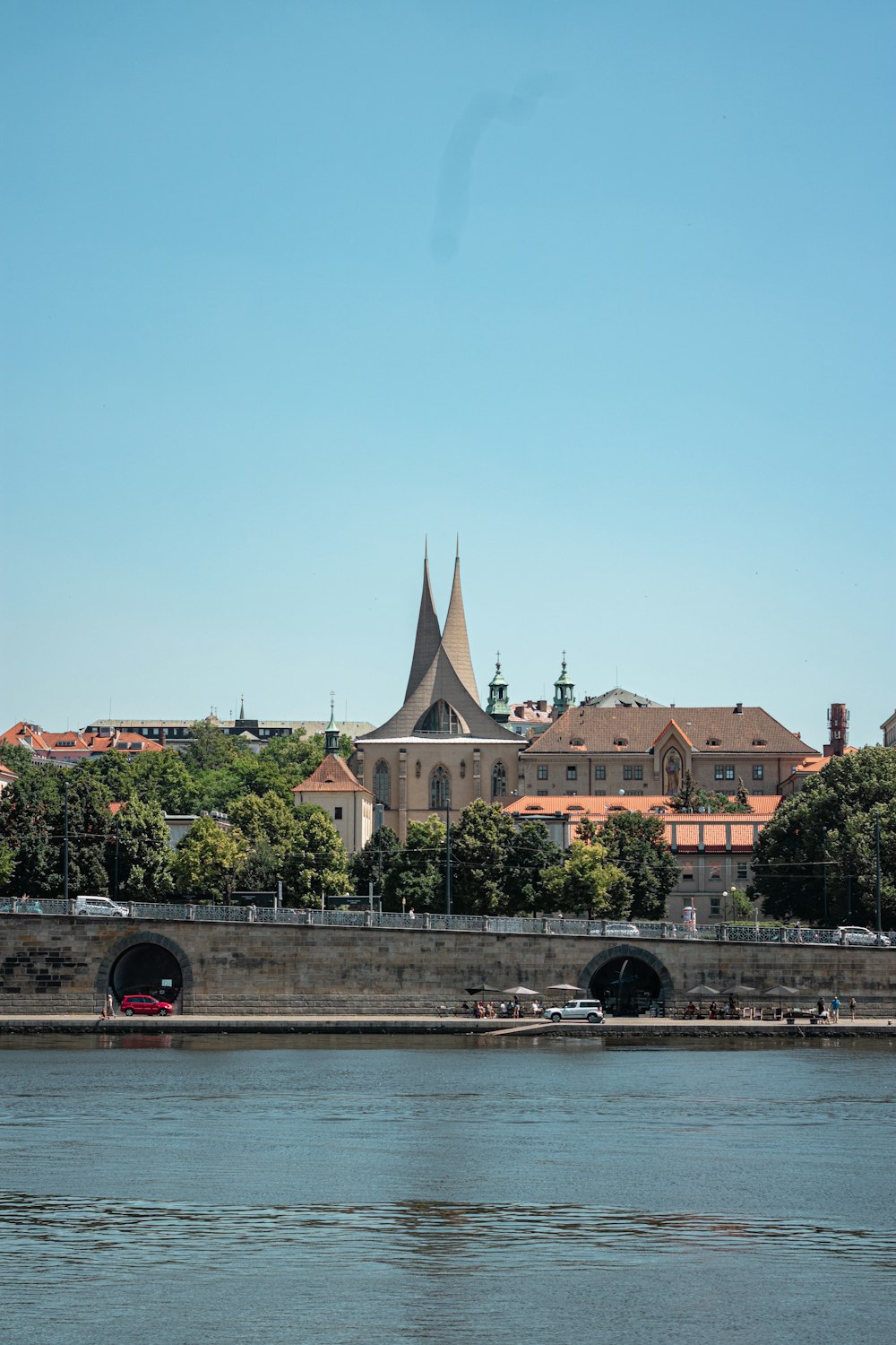 a bridge over a river leading to a large building