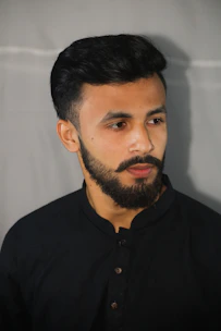 A well-groomed beard shaped to perfection under warm studio lighting.
