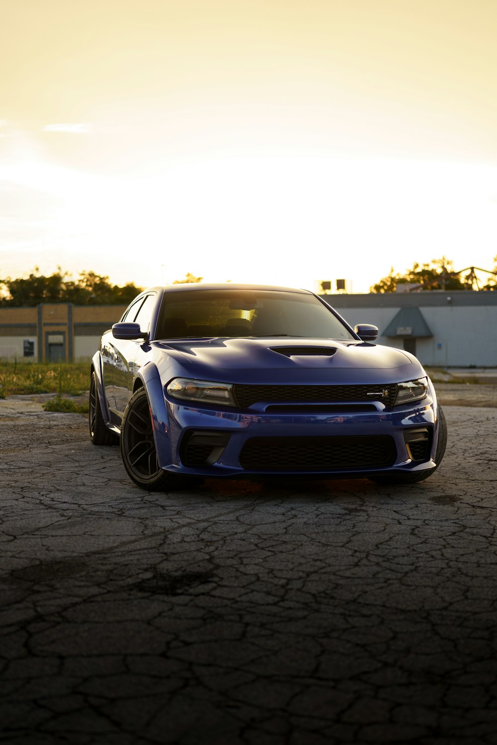 a blue car parked on a brick road