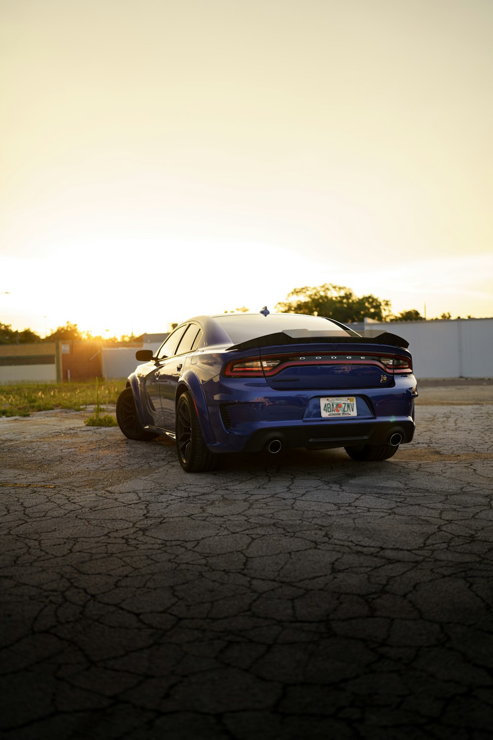 a blue car parked on a brick road