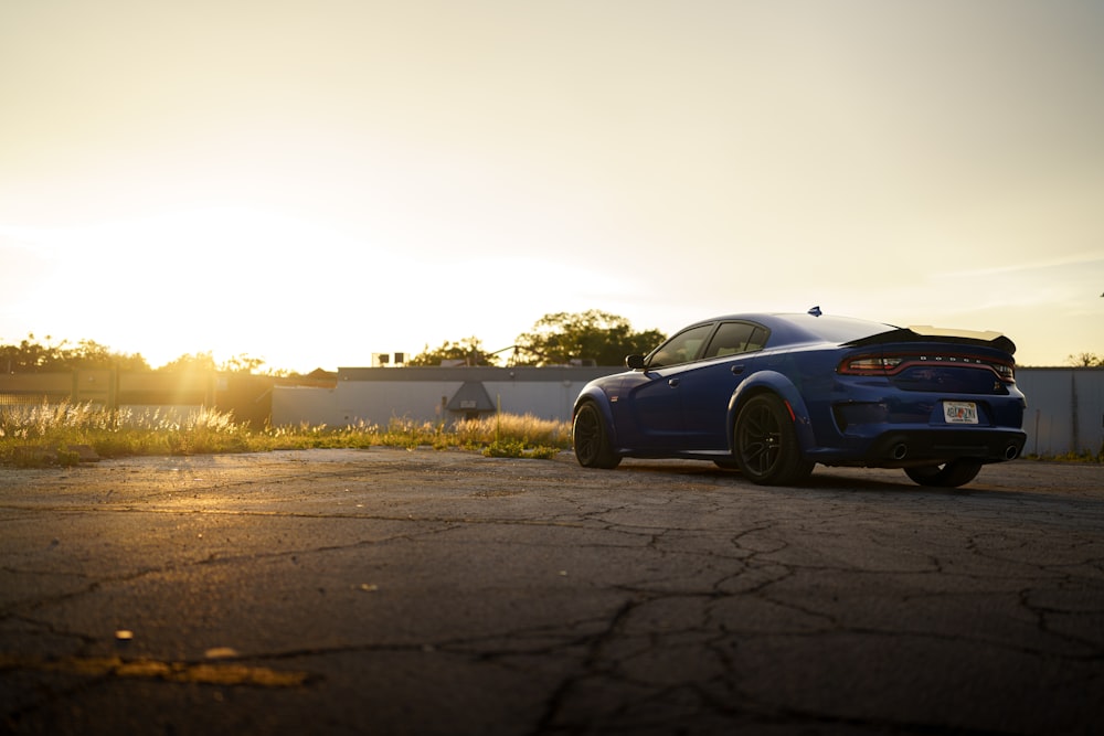 a blue car parked on a road