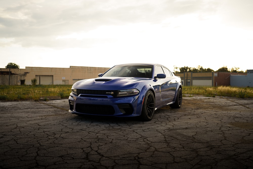 a blue car parked on a brick road