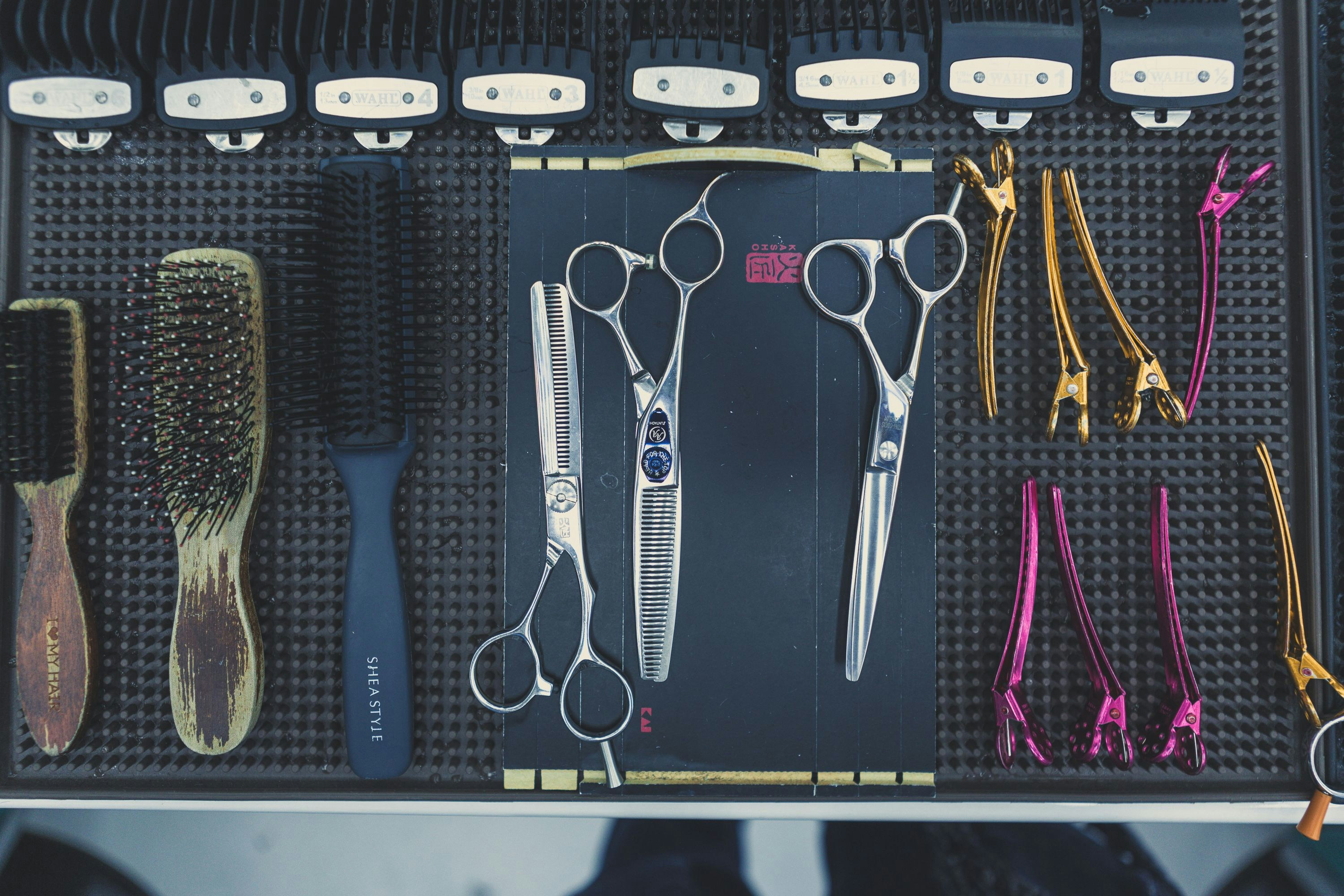 a group of scissors and combs
