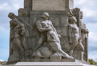 a stone monument with a group of people on it