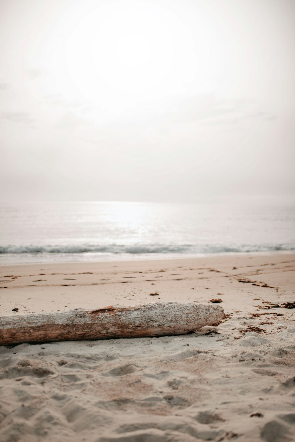 a sandy beach with waves crashing