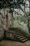a stone building with trees around it