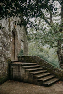a stone building with trees around it