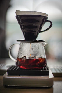 a coffee pot on a stack of books