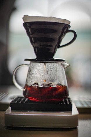 a coffee pot on a stack of books