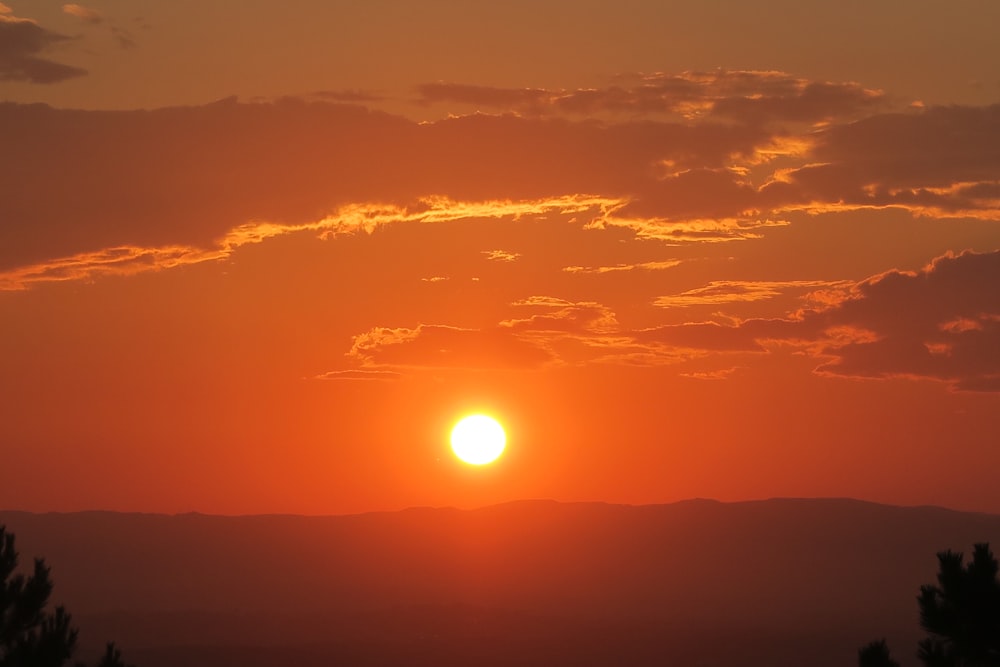 a sunset over a mountain