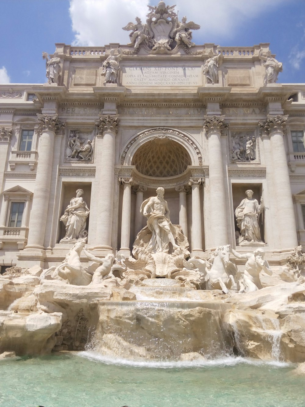 a large building with statues and a fountain in front of it with Trevi Fountain in the background