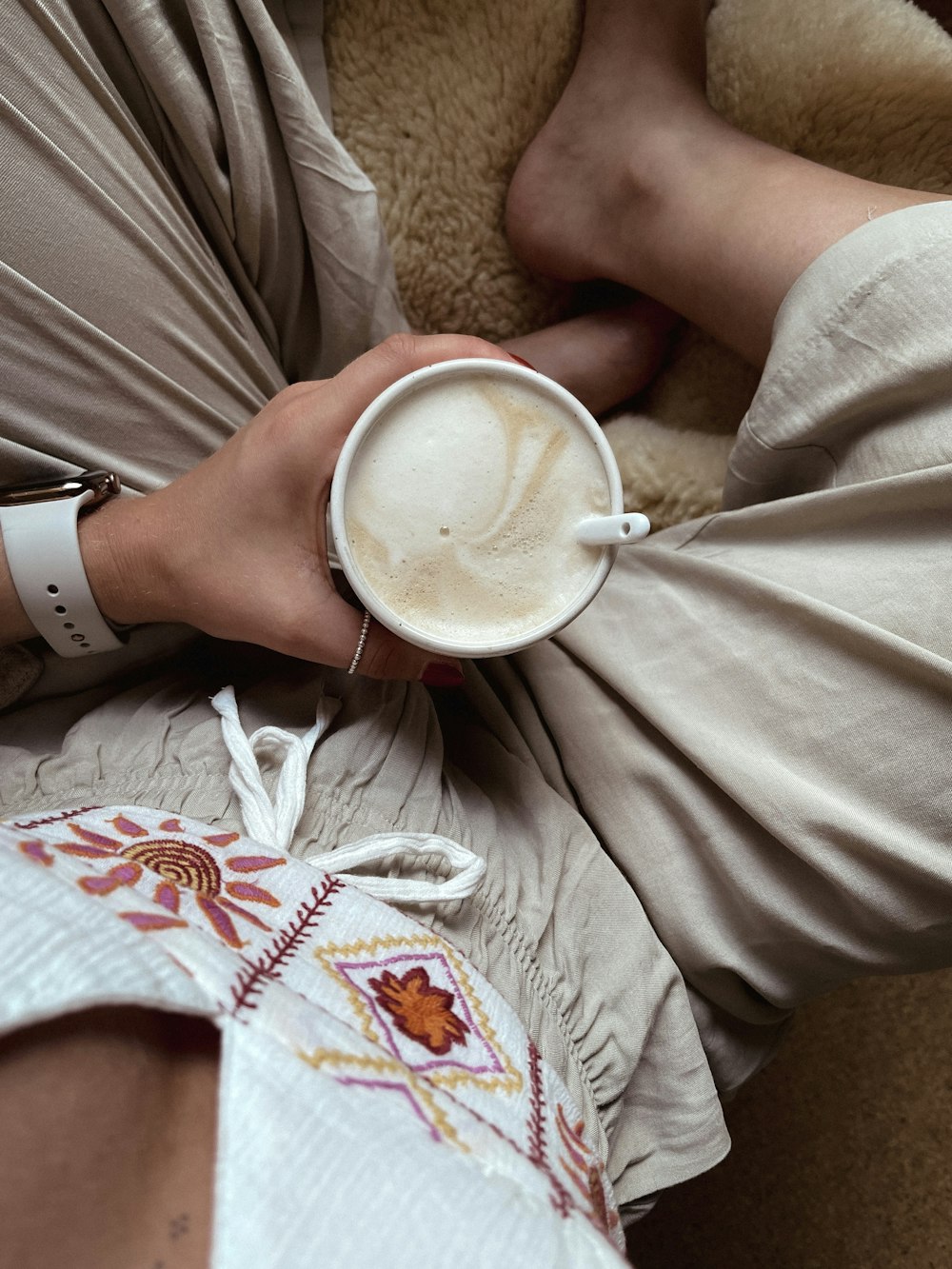 a person holding a white cup