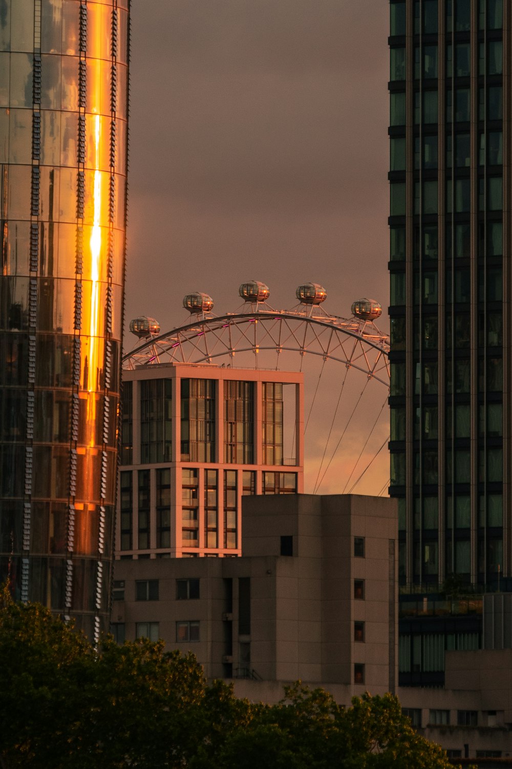 a ferris wheel between buildings