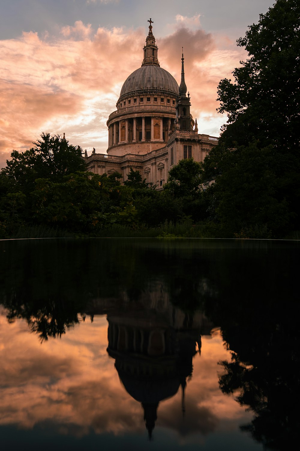 a building with a dome and trees around it