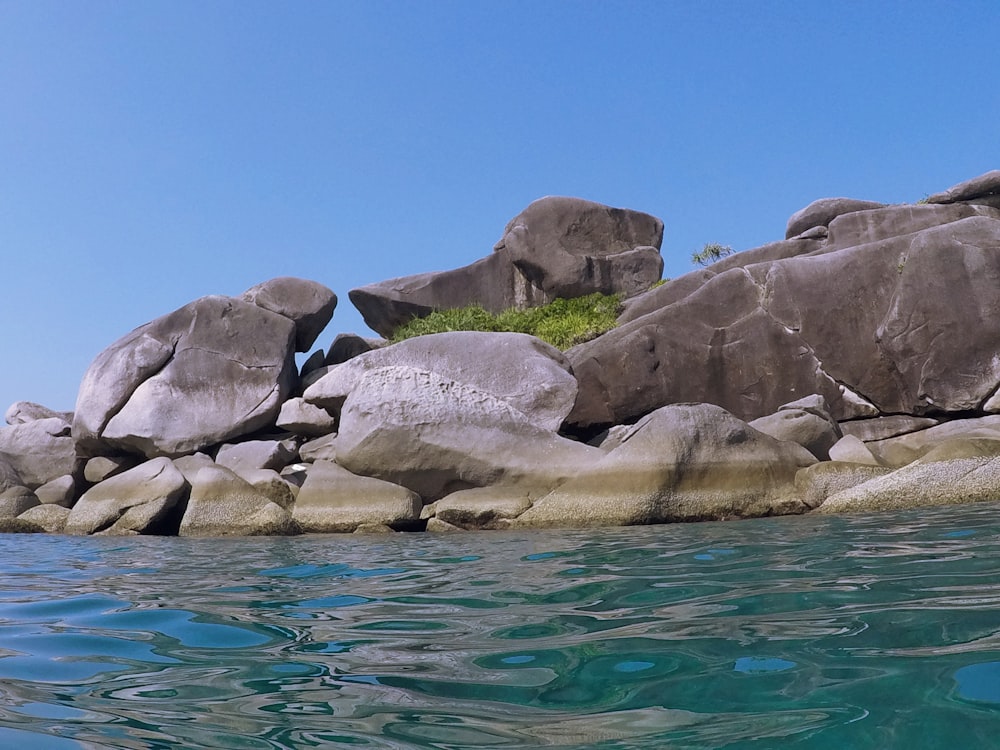 a group of large rocks in the water