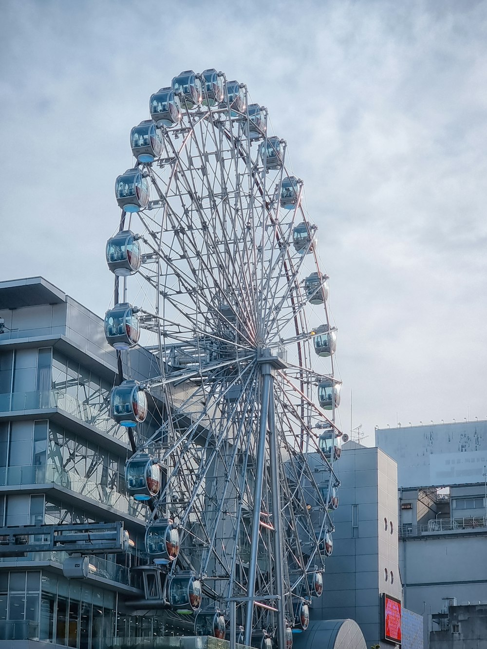 a ferris wheel with buildings in the background