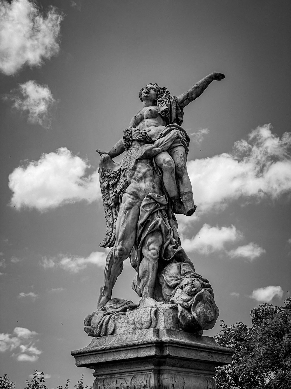 a statue of a man holding a woman