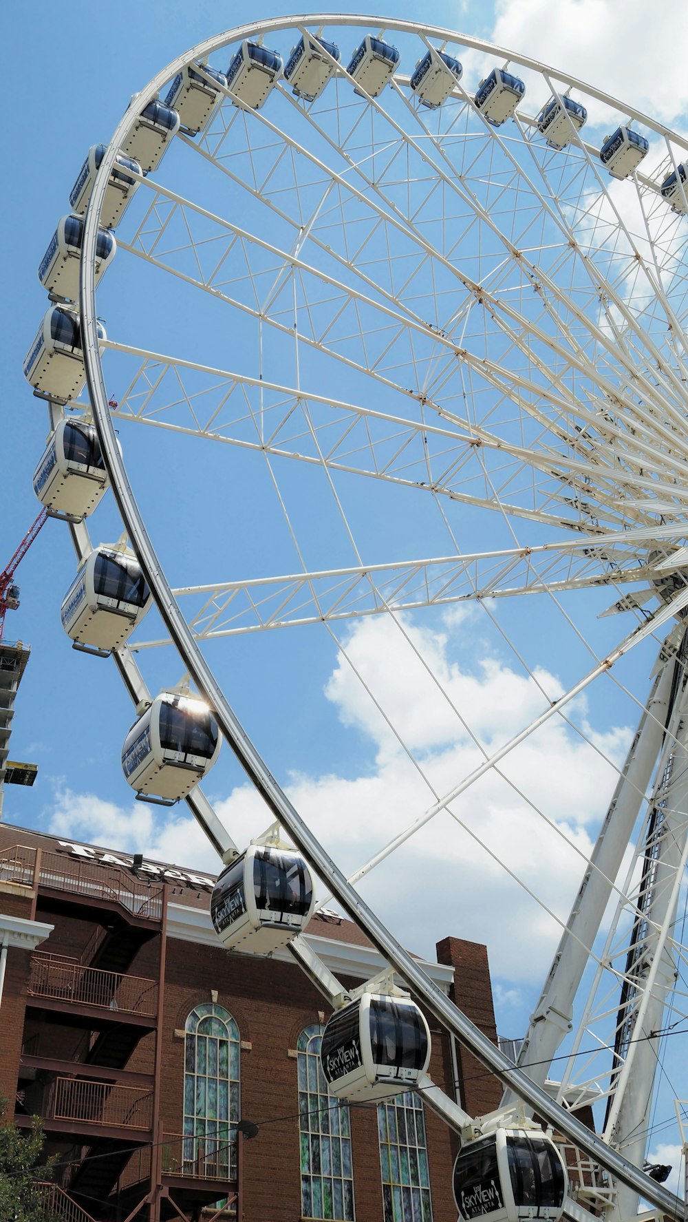 a ferris wheel with a building in the background