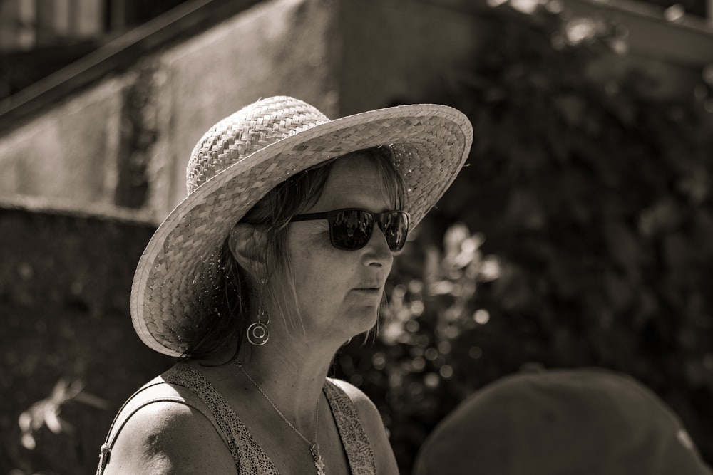 a woman wearing a hat and sunglasses