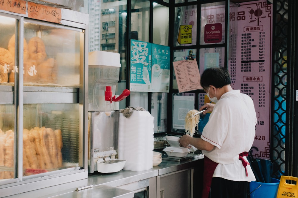 a man standing next to a counter with food on it