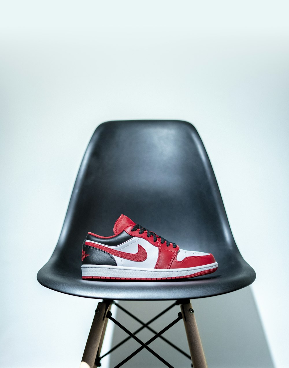 a black and red shoe on a black chair