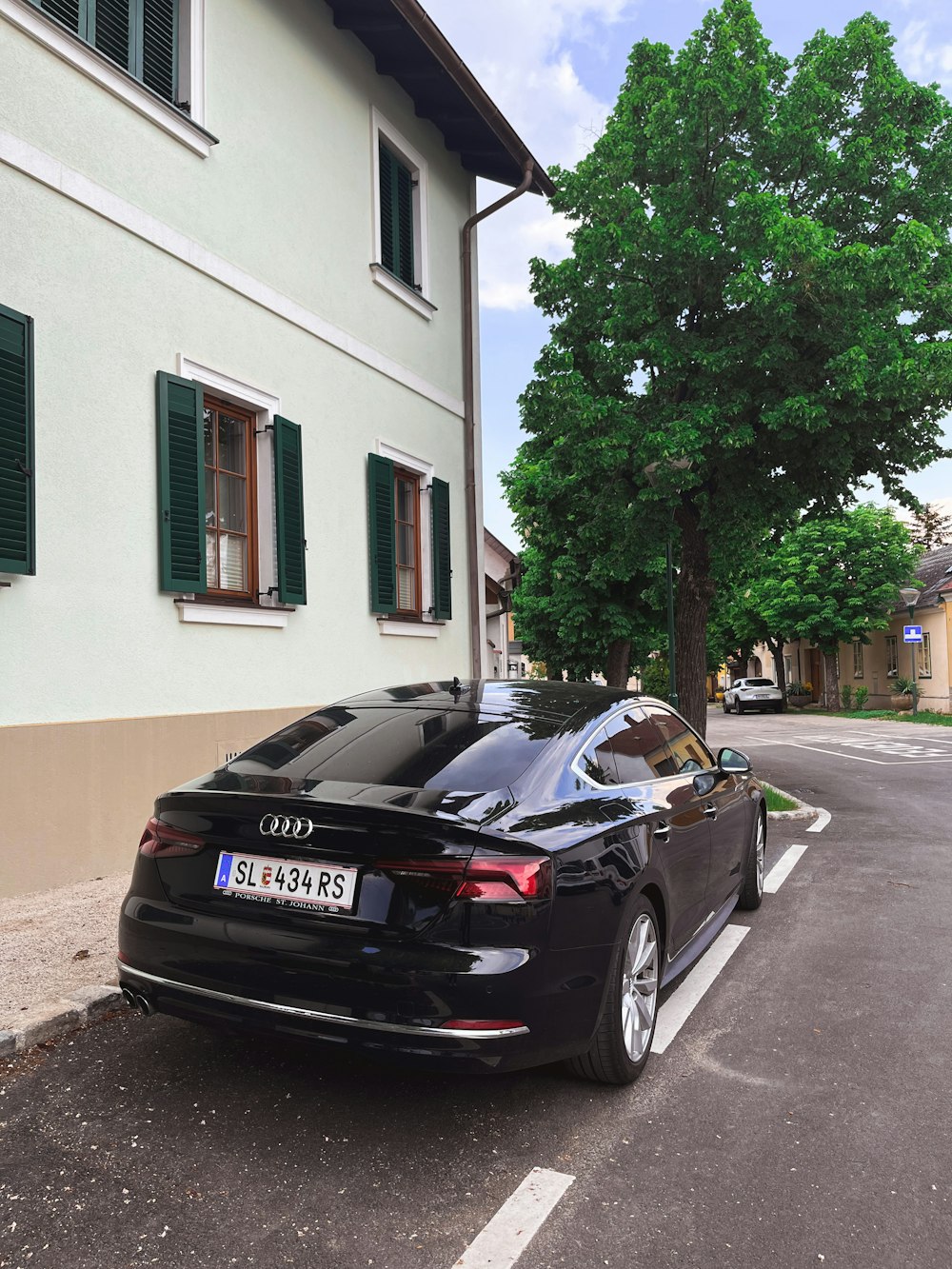 a black car parked on the side of a road