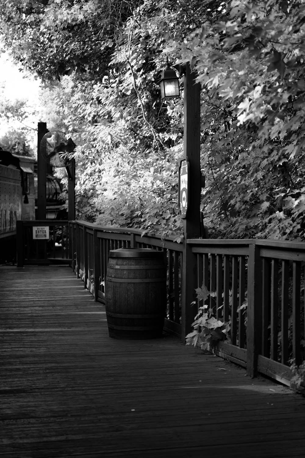 a wooden walkway with a lamp post