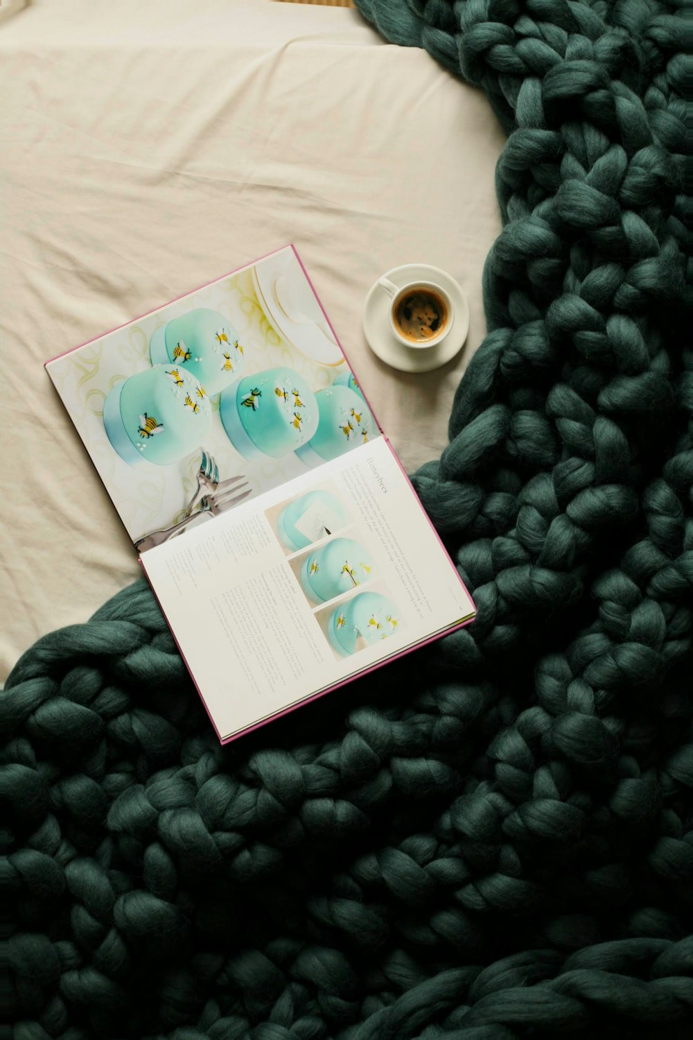 a book and a cup of coffee on a blanket