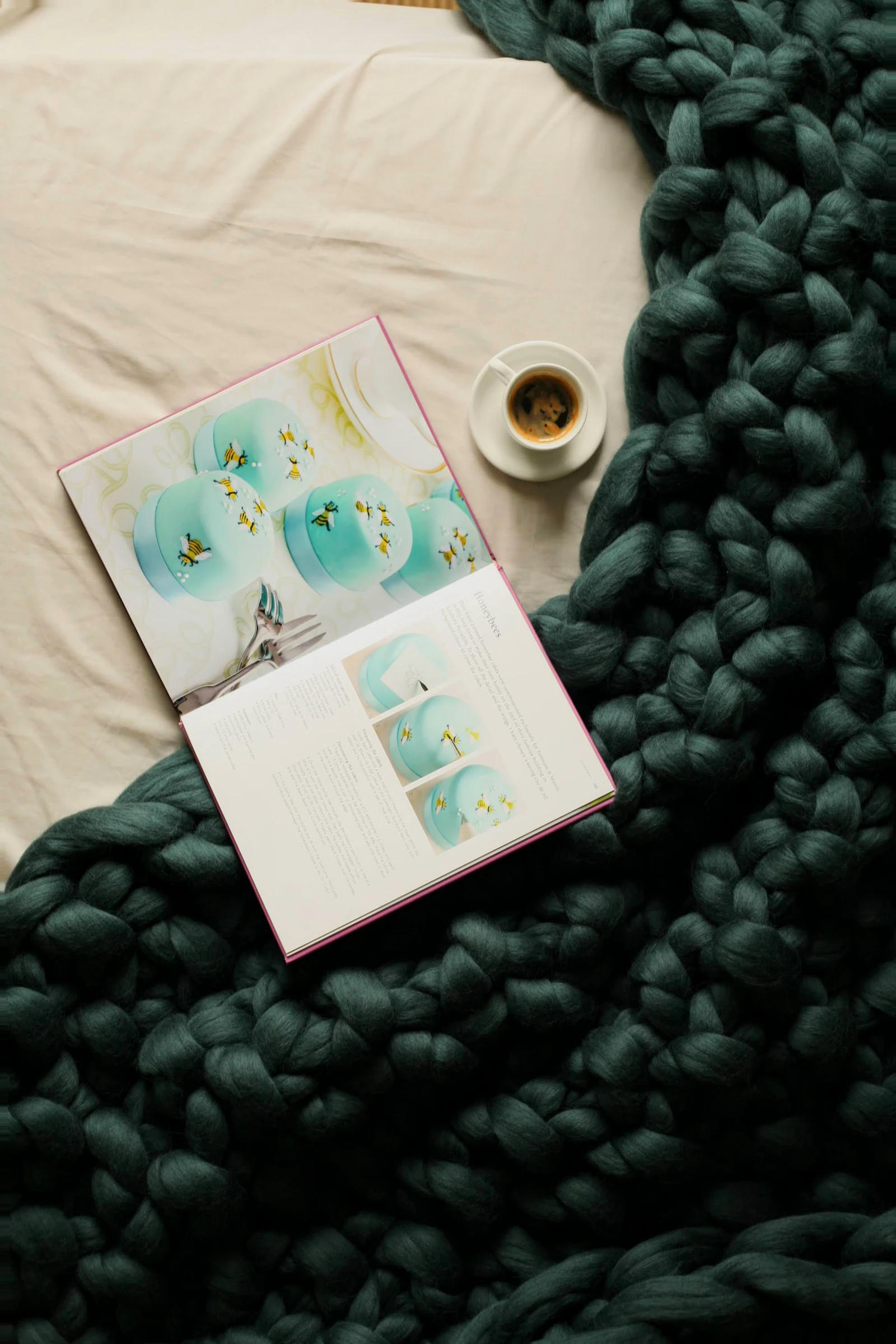 A book and cup of coffee on a blanket