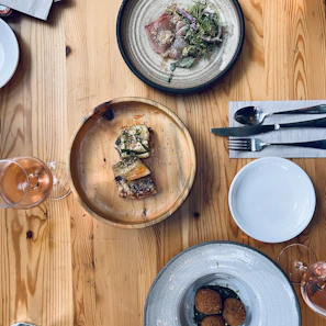 An overhead shot of a wooden table set with various traditional dishes and drinks.