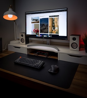 A clean, minimalistic workspace with a high-resolution digital art gallery displayed on a sleek monitor.